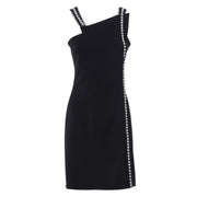 Little black dress with asymmetric neck and stripes of pearls