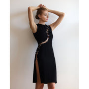 Short black dress with an S-shaped cut-out band with piercings