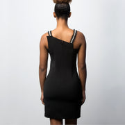 Little black dress with asymmetric neck and stripes of pearls